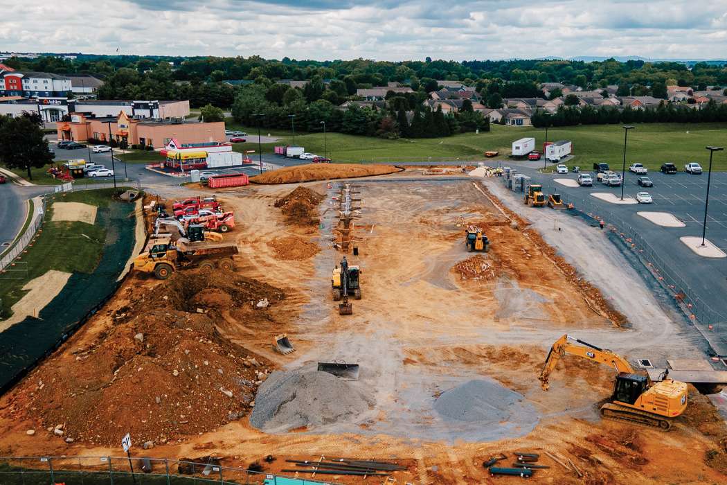 Excavators digging large hole to eventually build a building there