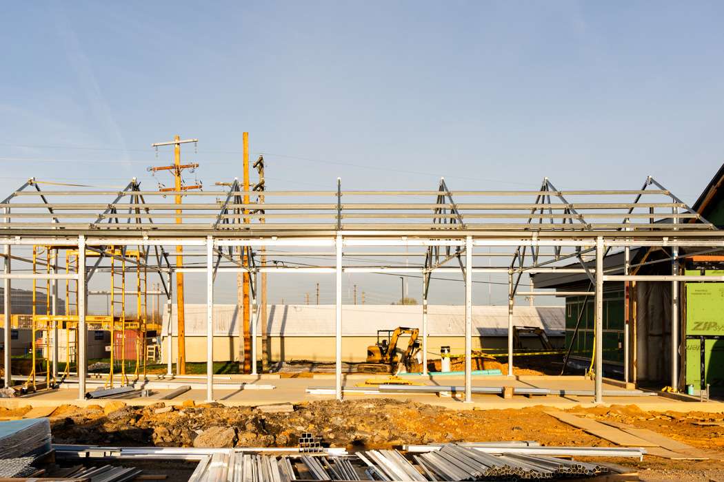 A metal framework for a large building is under construction.