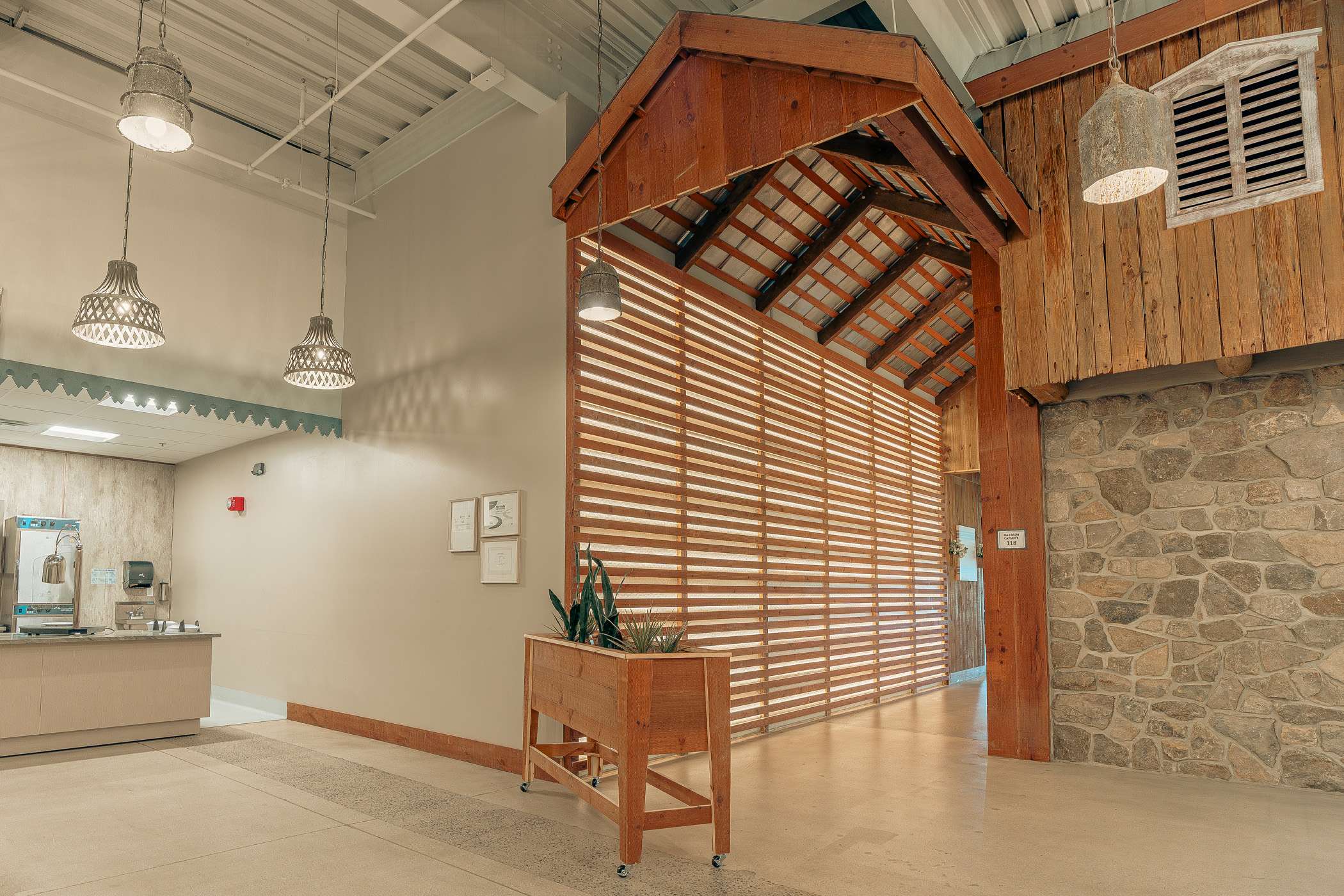 A modern interior space features a unique wooden wall and ceiling design.