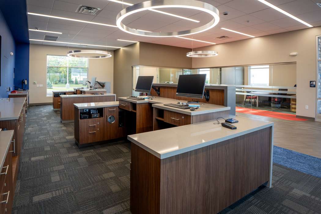 Teller workstations with modern lighting and computers.